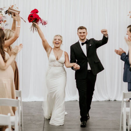 a man and woman walking down a aisle